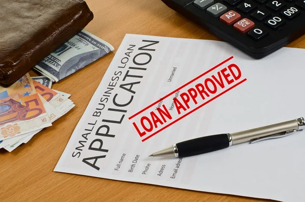 Small business loan application lies on the table — Stock Photo, Image