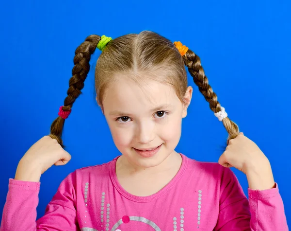 The young girl shows two braids — Stock Photo, Image