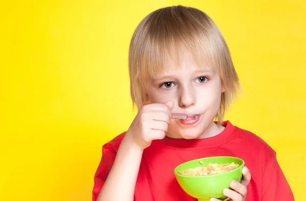 Niño rubio comiendo hojuelas de maíz — Foto de Stock