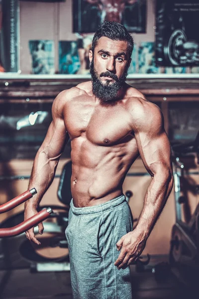 Muscle man in gym — Stockfoto