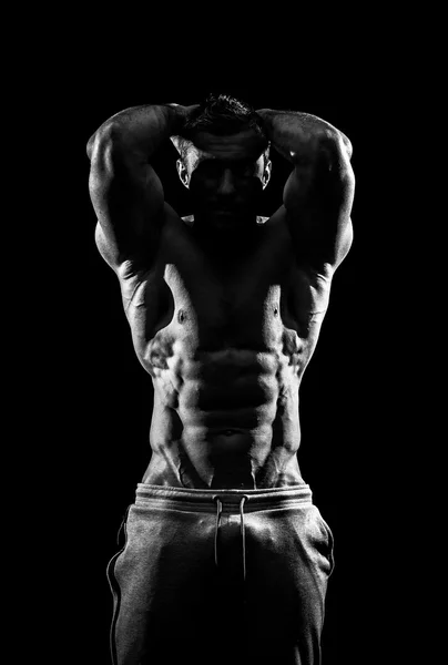 Bodybuilder, posing on black — Stock Photo, Image