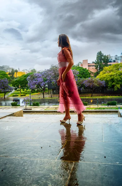 young woman in the rain on a summer day