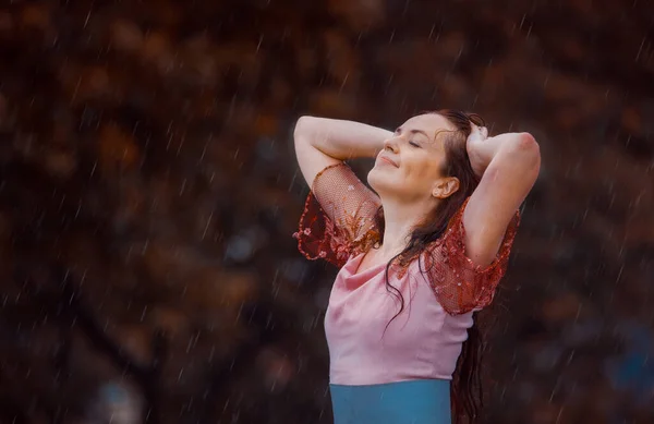 young woman in the rain on a summer day