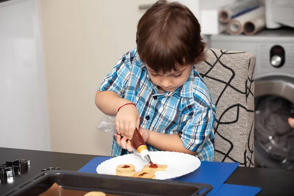 Happy Boy Puts Jam Cookies — Stock Photo, Image