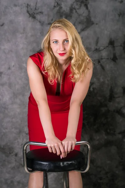 Young Blonde Red Dress Holding Chair Gray Background — Stock Photo, Image