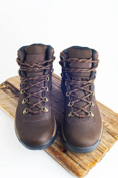 hiking brown boots with sturdy soles on a white background