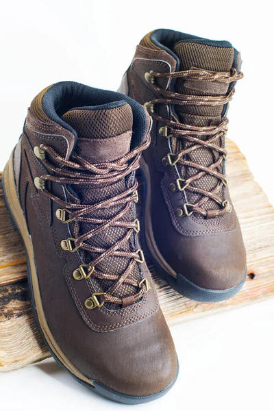 hiking brown boots with sturdy soles on a white background