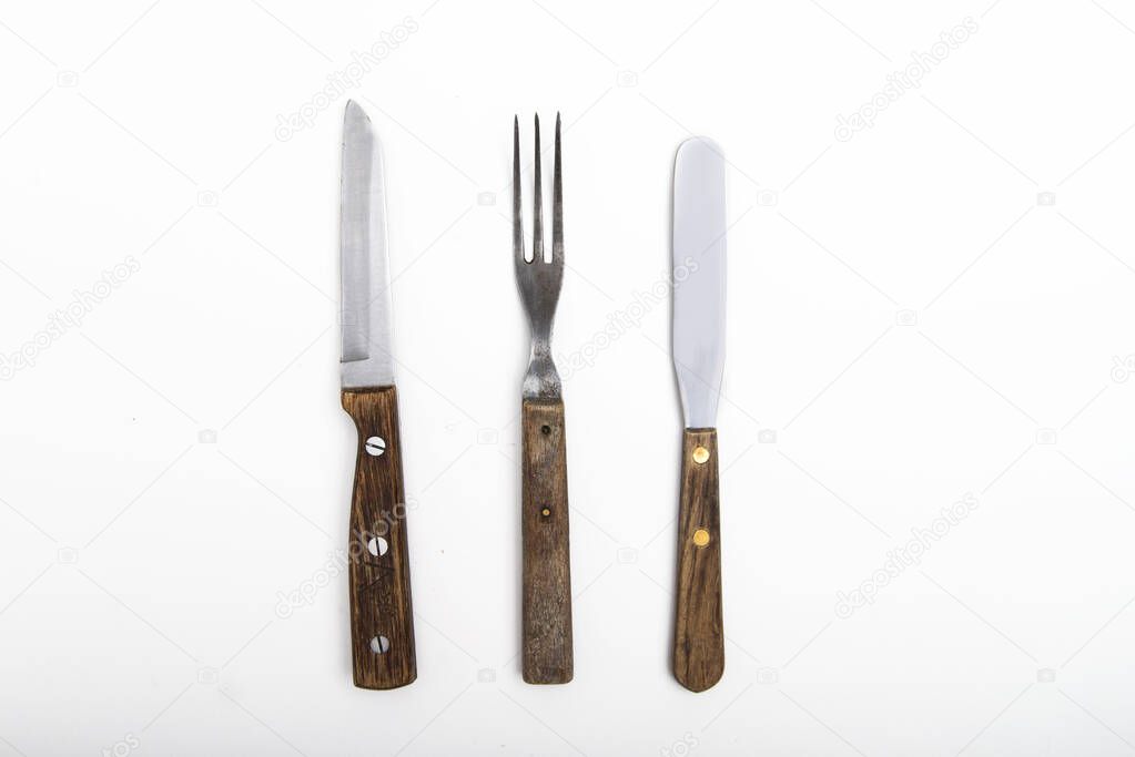 vintage cutlery with wooden handle on white background
