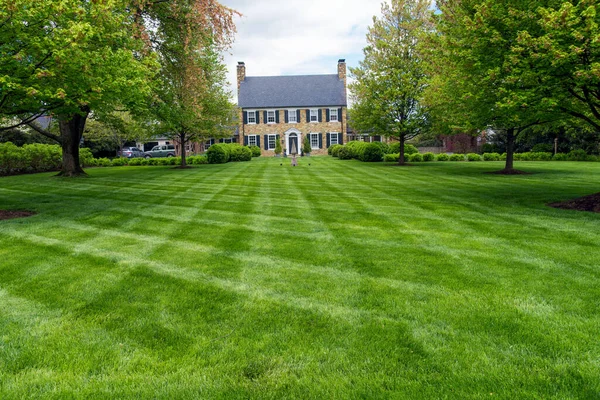 Freshly cut lawn in garden in front of an ancient villa, America.