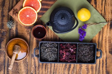 Siyah dökme demir antika çaydanlık, ahşap bir masanın üzerinde çeşitli çaydanlıklar. Yukarıdan görünüm