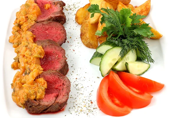 Meat with blood and vegetables — Stock Photo, Image