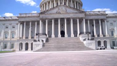 Güneşli bir günde, ulusal bir simge olan Capitol 'ün cephesi, adımları ve kubbesini görmek. Kamera yukarı doğru döner..