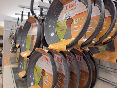 Non-stick frying pans and cookware are displayed on a shelf in a Marshalls retail store in Virginia.