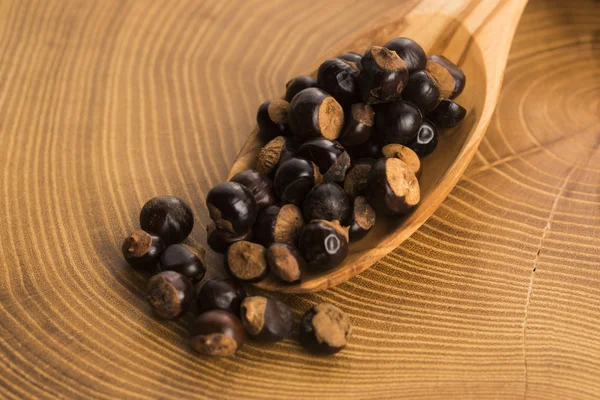 Guarana seeds on wooden spoon — Stock Photo, Image