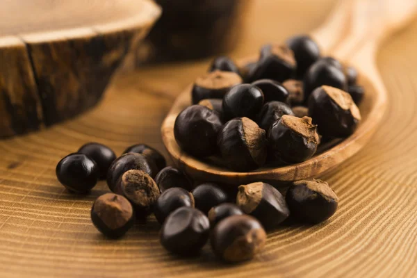 Guarana seeds on wooden spoon — Stock Photo, Image