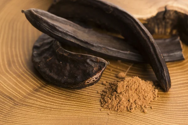 Carob pods and carob powder — Stock Photo, Image