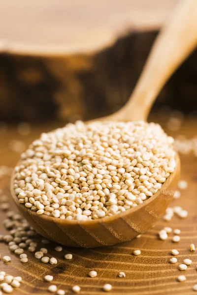 White quinoa seeds on a wooden background — Stock Photo, Image