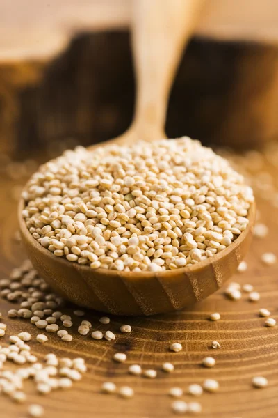 White quinoa seeds on a wooden background — Stock Photo, Image