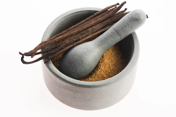 Brown vanilla sugar and vanilla beans in mortar — Stock Photo, Image