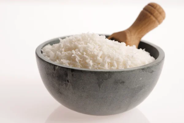 Coconut flakes in ceramic bowl — Stock Photo, Image