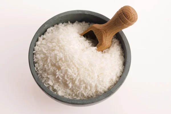 Coconut flakes in ceramic bowl — Stock Photo, Image