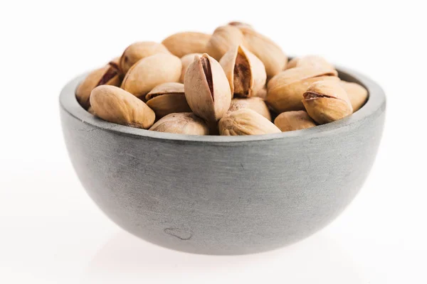 Bowl of pistachios on white background — Stock Photo, Image