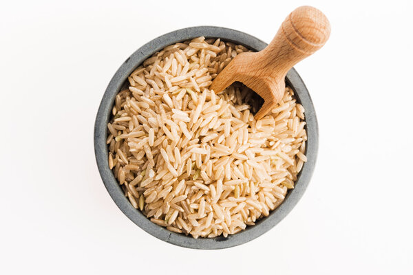brown rice in a bowl isolated on white background