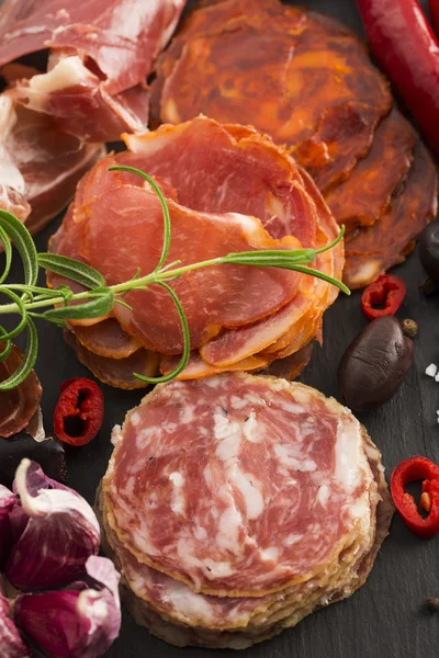 stock image a pile of different spanish embutido, jamon, chorizo and lomo em