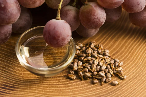 grape seed oil on wooden background