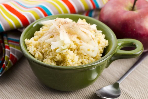 Portion of sweet millet porridge with apple and cinnamon — Stock Photo, Image