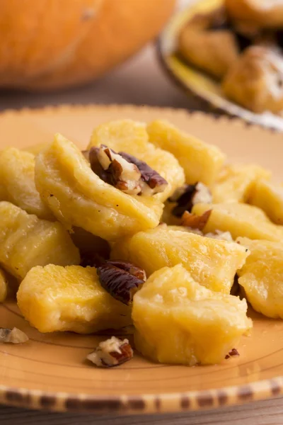 Homemade pumpkin gnocchi with pecan nuts — Stock Photo, Image