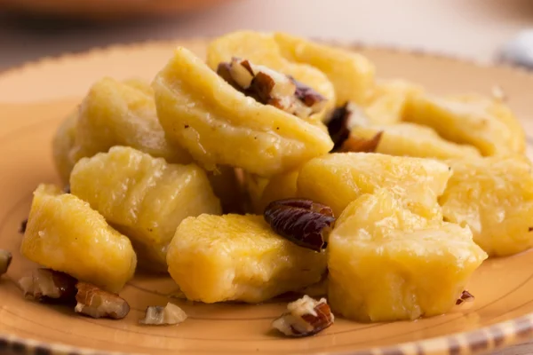 Homemade pumpkin gnocchi with pecan nuts — Stock Photo, Image