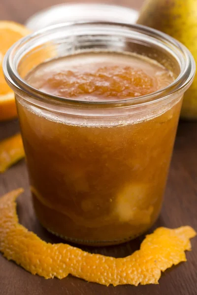 Glass of pear jam with orange — Stock Photo, Image