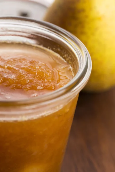Glass of pear jam with orange — Stock Photo, Image