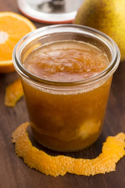 Glass of pear jam with orange — Stock Photo, Image