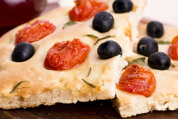 Focaccia con aceitunas negras, tomates y albahaca —  Fotos de Stock