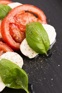 Caprese salad with mozzarella, tomato, basil and balsamic vinega clipart