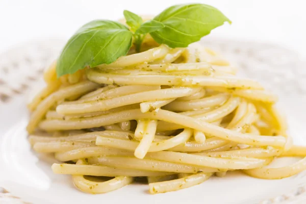 Italian pasta spaghetti with pesto sauce and basil leaf Royalty Free Stock Photos