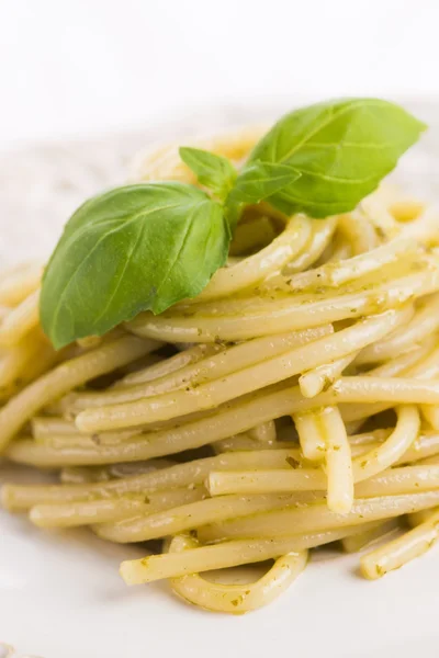 Italian pasta spaghetti with pesto sauce and basil leaf Stock Image