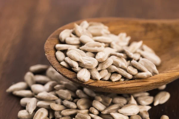 Sunflower seed with a wooden spoon — Stock Photo, Image