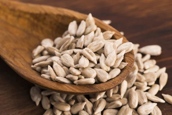 Sunflower seed with a wooden spoon — Stock Photo, Image