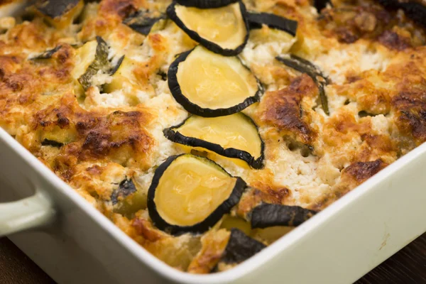 Casserole with cheese and zucchini in baking dish — Stock Photo, Image