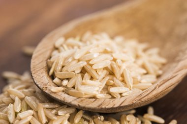 Spoon of brown rice close up clipart