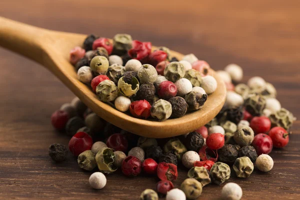 Mixed green, red, white and black peppercorns