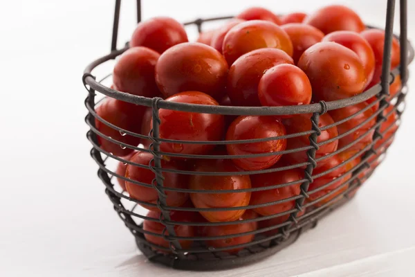 Cherry tomatoes in basket — Stock Photo, Image