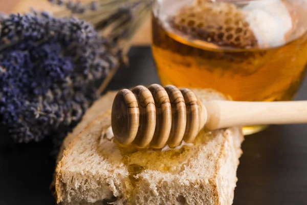 Bread and jar of lavender honey — Stock Photo, Image