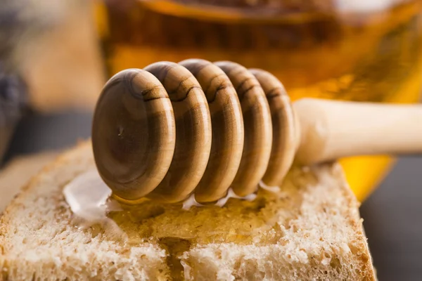 Bread and jar of lavender honey — Stock Photo, Image