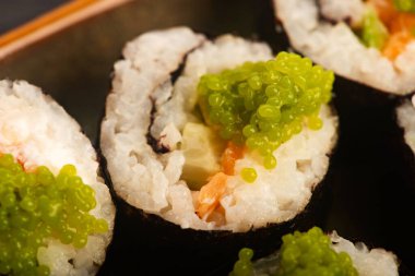 Somon ve yeşil Wasabi havyarlı California suşi ruloları.