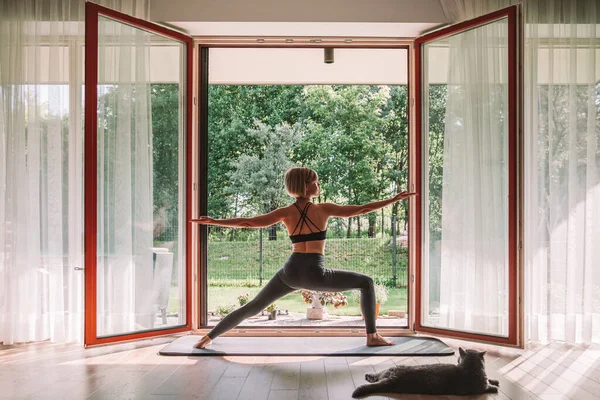 Young Woman Standing Warrior Position Front Opened Window While Doing — 图库照片