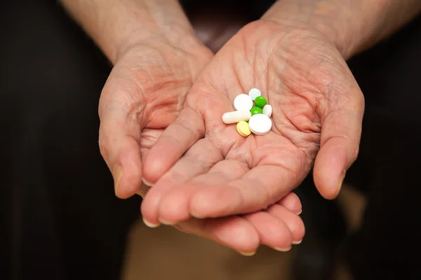 Palm with pills and vitamins — Stock Photo, Image